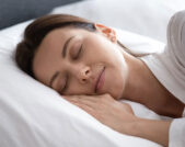 Woman sleeping on her side with her hand on the pillow